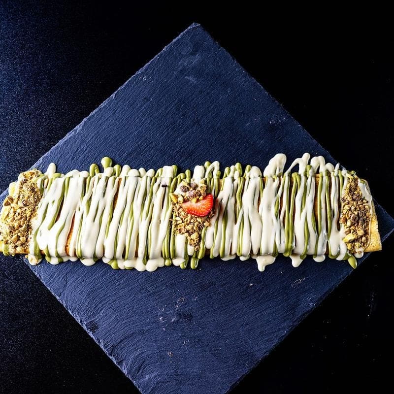 The Dubai Crepe with kunafa and pistachio on black slate