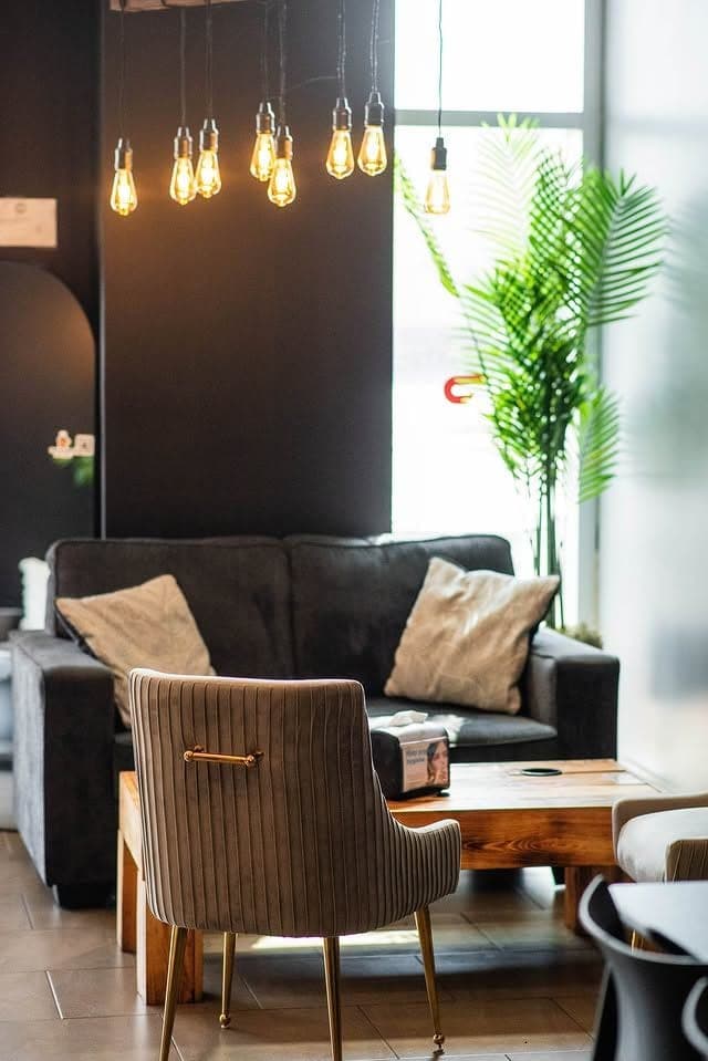 The seating area at Dip N Crepe: sofas, pendant lights and a low table